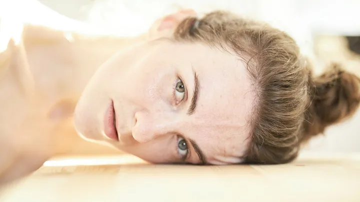 Woman resting during a bout of severe cluster headaches