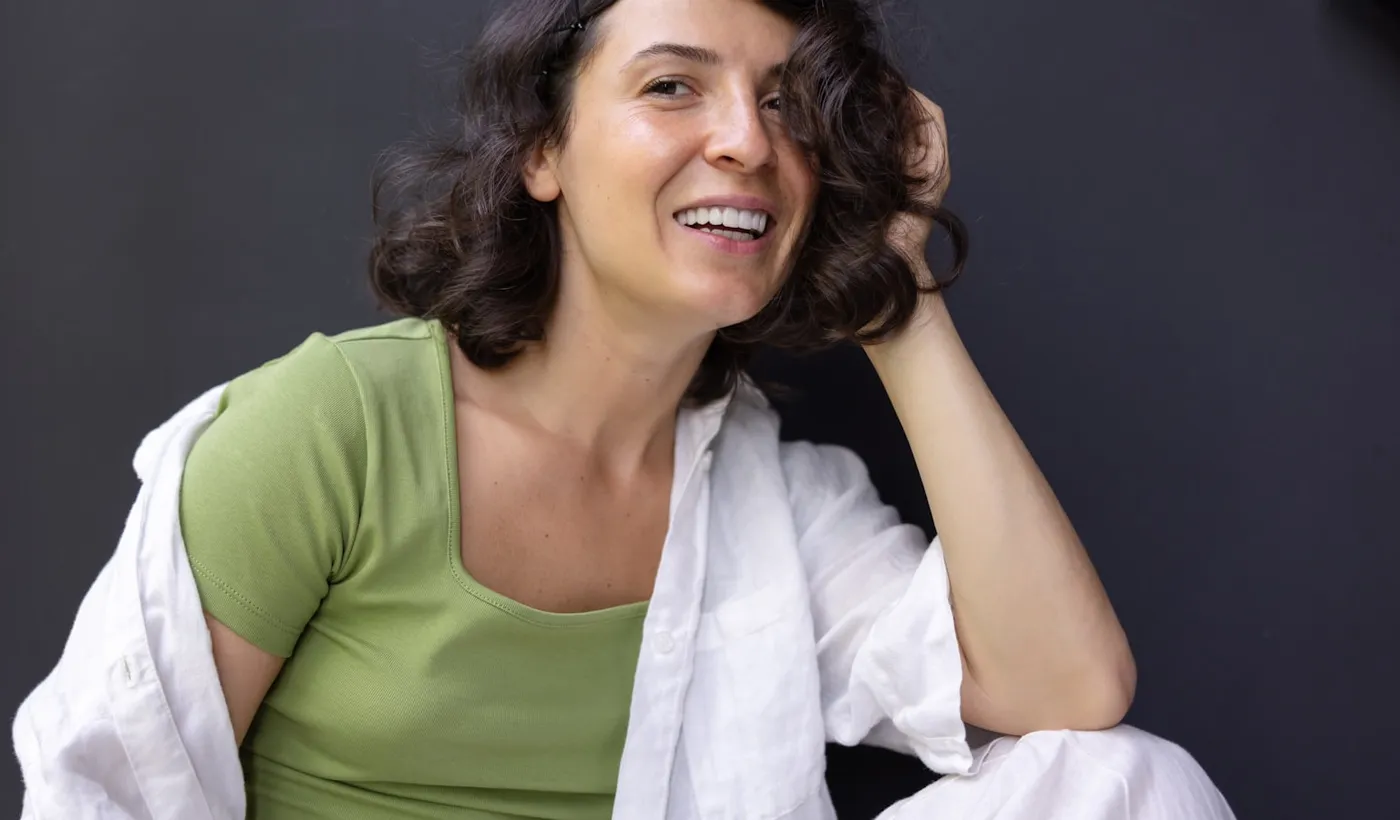 Woman holding her head while considering complex migraine symptoms