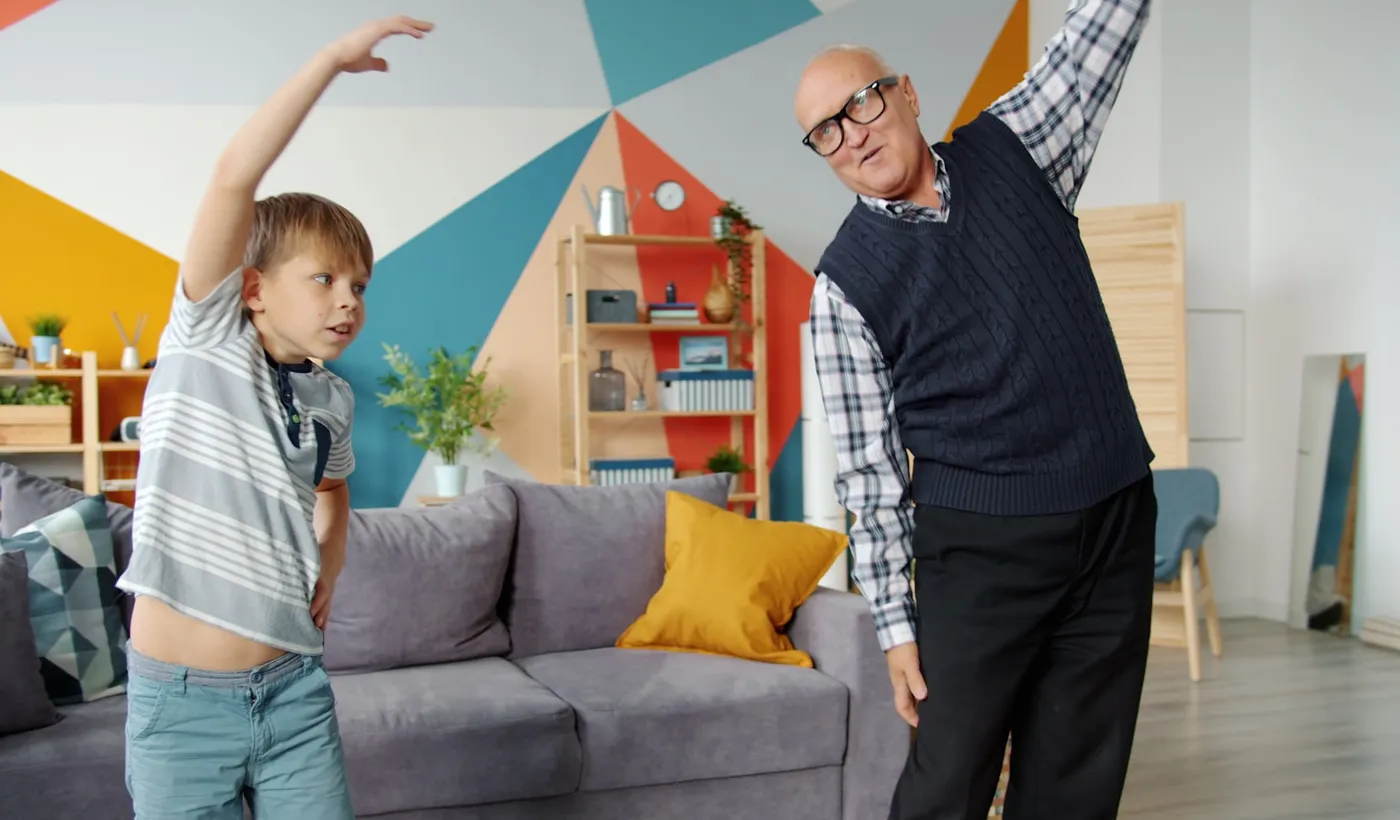 Grandfather and grandson exercising together while learning about exertion headache safety