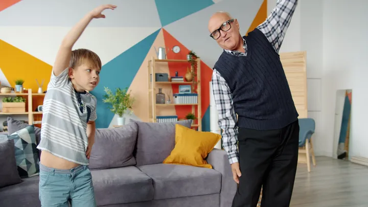 Grandfather and grandson exercising together while learning about exertion headache safety