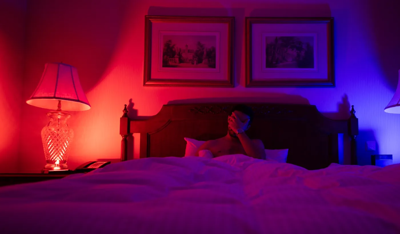 Person resting in bed while dealing with frequent recurring headaches