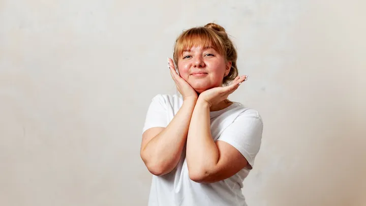 Person holding their face while learning about hemiplegic migraine and stroke-like symptoms