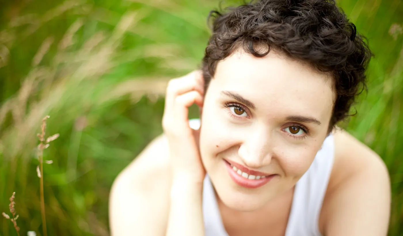 Woman resting outdoors after a brief ice pick headache