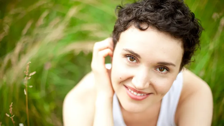 Woman resting outdoors after a brief ice pick headache