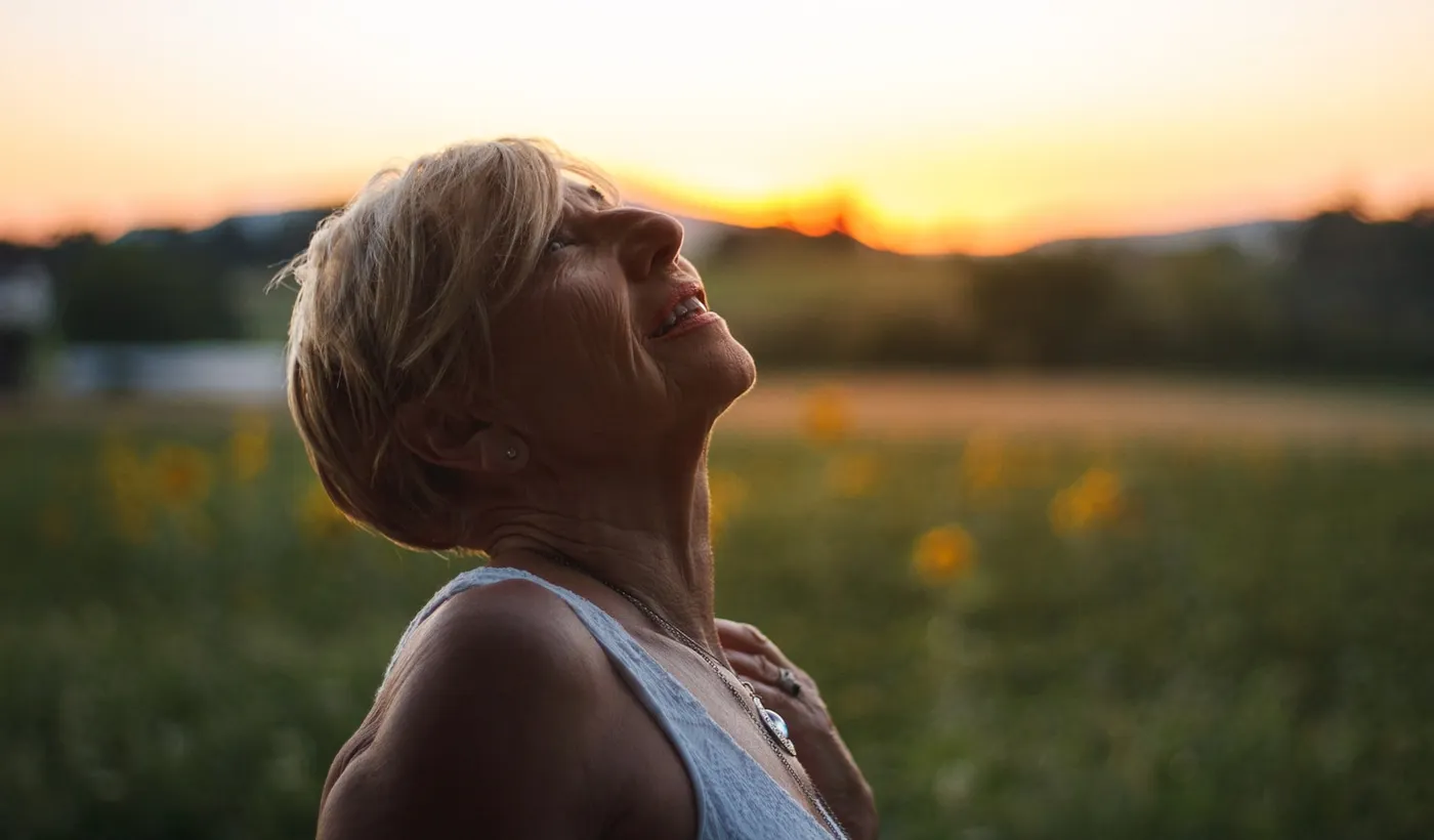 Woman resting outdoors while recovering from frequent rebound headaches