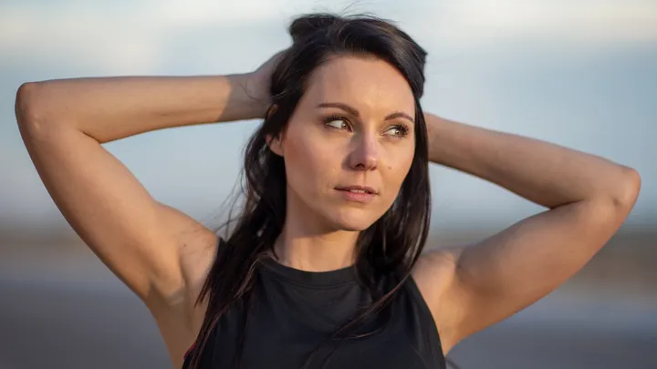 Woman resting with facial pressure that could be sinus-related or migraine