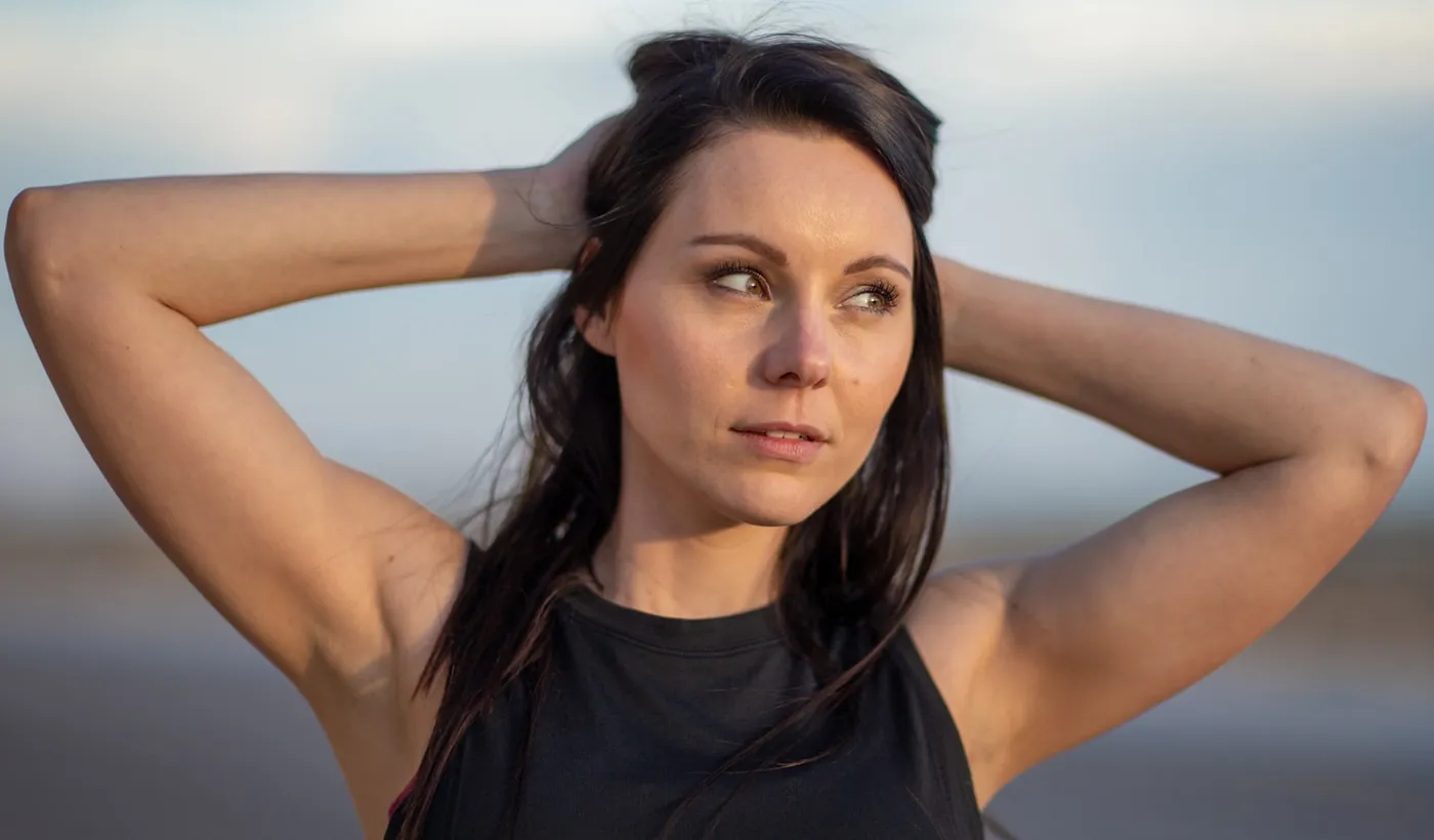Woman resting with facial pressure that could be sinus-related or migraine